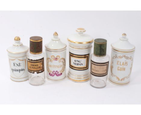 Six 19th century drug jars, comprising four white glazed ceramic vessels with Latin titles and gilt ornament, the tallest 24c