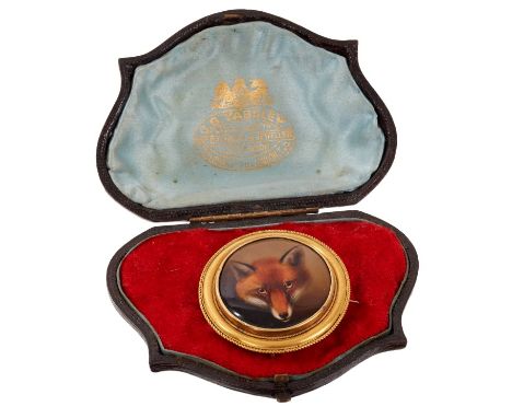 Victorian enamel brooch, finely painted depicting a fox, in circular gold mount with glazed locket compartment to the reverse