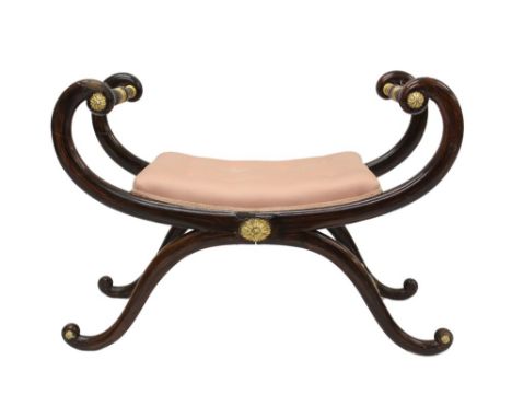 A Regency simulated rosewood and parcel gilt window seat, X-frame form with button upholstered seat and gilt boss ornament