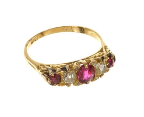 Edwardian ruby and diamond five stone ring with three mixed rubies and two old cut diamonds in carved gold setting with diamo