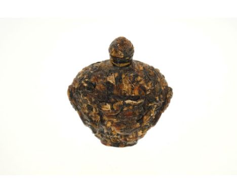 Chinese amber snuff bottle, the carved decoration with birds and foliage and lion’s head ring handles, 80mm high