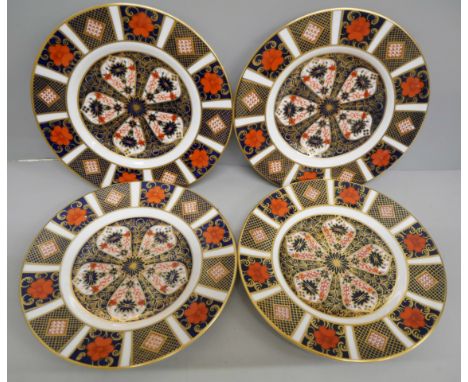 A set of four Royal Crown Derby 1128 pattern tea plates, three seconds, one first quality