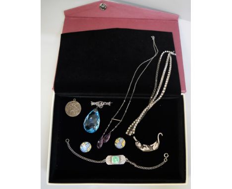A silver panther brooch, a silver and enamel St Christopher ID bracelet, a pair of silver and enamel clip on earrings, a silv