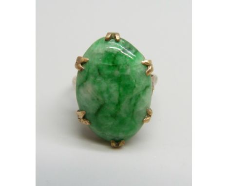 A 9ct gold ring set with a cabochon jade stone, stone size 1.4 x 2cm, 6.4g, N/O