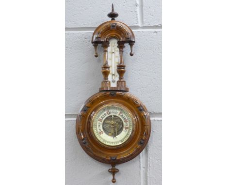A carved walnut wall barometer 
