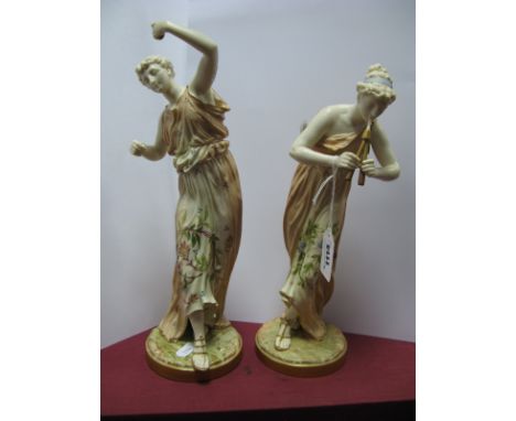 A Pair of Royal Worcester Porcelain Figures, modelled as maidens in floral decorated flowing robes, one playing pan pipes, th