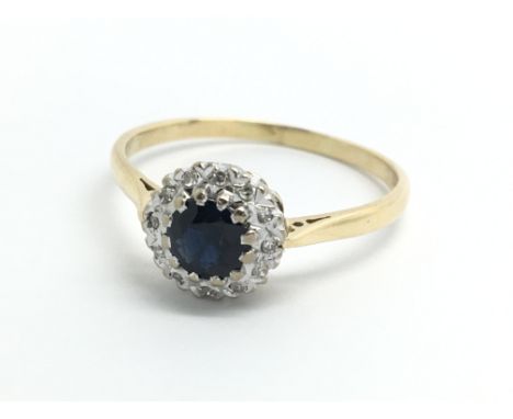 An 18ct yellow gold sapphire and diamond cluster ring, size approx U/V