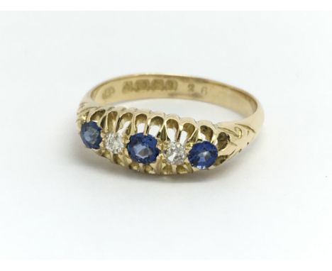 A vintage 18ct yellow gold ring having three sapphires and two diamonds, ring size approx M