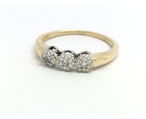 An 18ct yellow gold and diamond ring, small diamonds set in three rose shaped clusters, ring size approx K/L