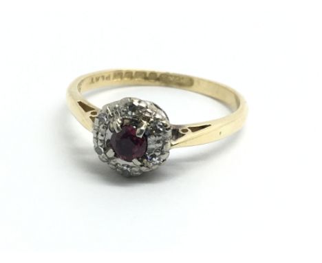 An 18ct yellow gold ruby and diamond cluster ring, size approx M/N