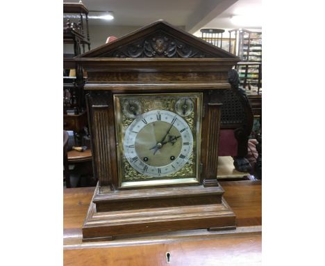 A late Victorian brass and silvered dial mantle clock.