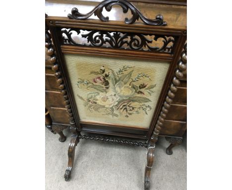 A Victorian walnut fire screen inset with tapestry panel flanked by barley Twist columns on cabriole legs .56 cm by 110 cm - 