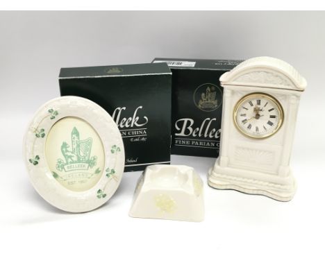 A Belleek porcelain clock with box, a photo frame with box and an ashtray