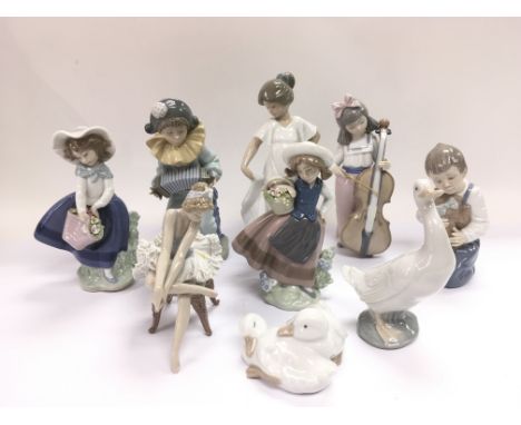 Another collection of Lladro and Nao figures of children and animals (9).