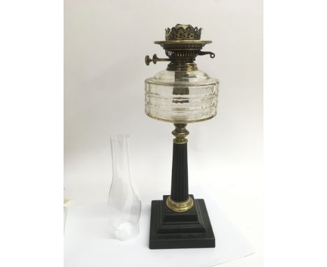 An iron Corinthian column oil lamp with a clear glass reservoir - NO RESERVE