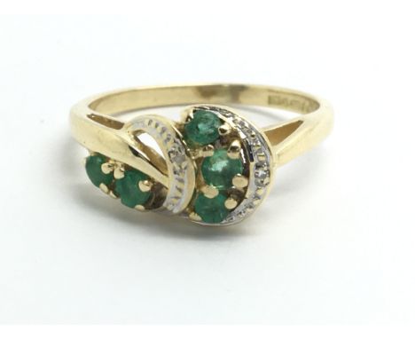 An 18ct yellow gold, emerald and diamond dress ring, size approx J/K