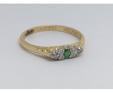 A vintage diamond and emerald ring, size approx K/L