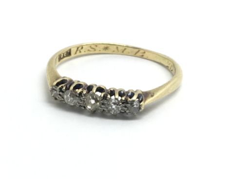 An 18ct yellow gold ring set with a row of five diamonds, ring size approx M/N