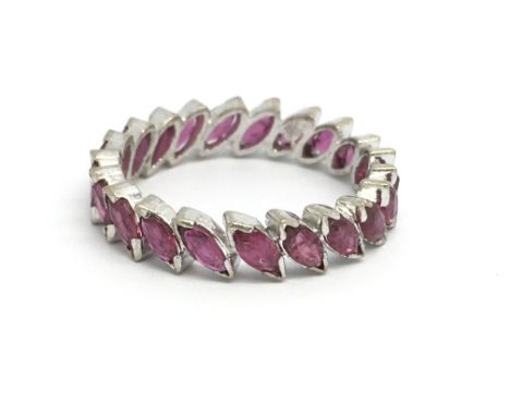 An 18ct white gold and ruby full eternity ring, size approx K/L