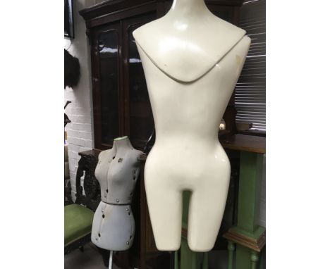 A mannequin on stand and a dress makers dummy .