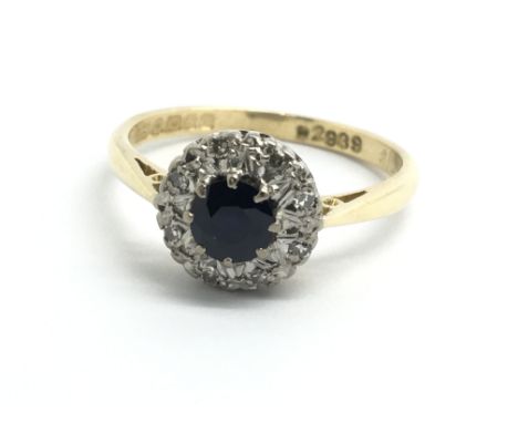 An 18ct yellow gold, sapphire and diamond cluster ring, size approx N/O