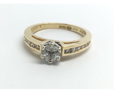 An 18ct yellow gold ring set with three marquise cut diamonds and a row of diamonds on the shoulders, ring size approx K/L