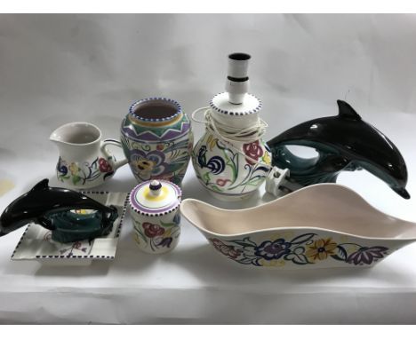 A collection of Poole pottery including two dolphins.