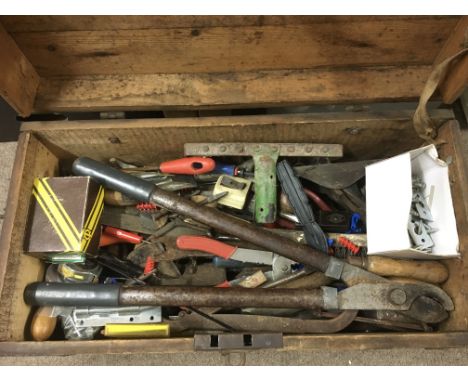 An old wooden tool chest containing various tools