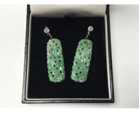 A pair of white gold, diamond and carved jade pendant earrings, approx 0.30ct each