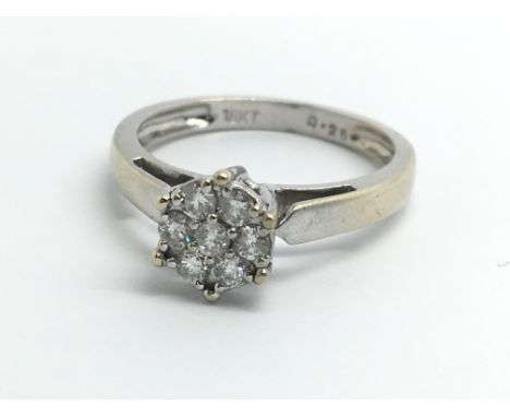 An 18ct white gold ring set with seven diamond in a rose style, approx 0.25ct, ring size approx K