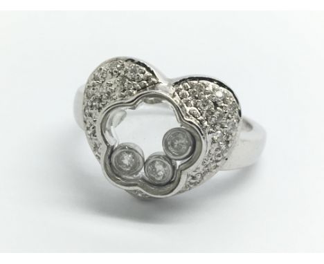 A 14ct white gold and diamond ring, with three floating diamonds in a heart shaped cluster, ring size approx M