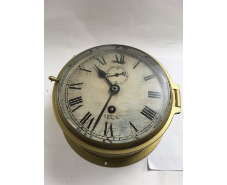 A Brass cased smiths Astral ships style clock with With Roman numerals.