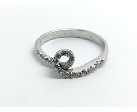 An 18ct white gold and diamond ring in the shape of a loop, approx 0.25ct, size approx N/O