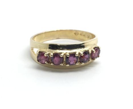 A 9ct yellow gold ring with a row of five rubies, size approx M