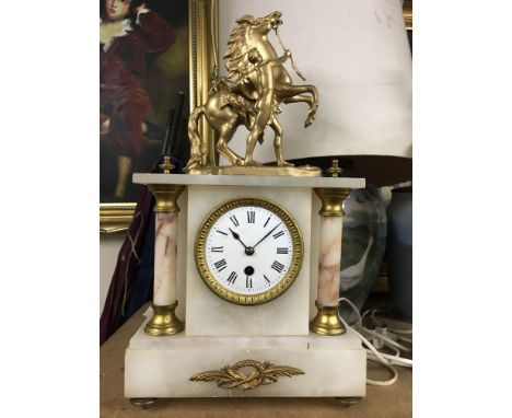 A alabaster mantel clock the top surmount with a gilt Marley horse .