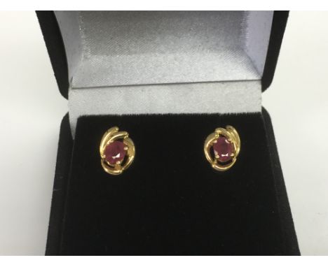 A pair of 18ct gold and ruby earrings, approx 1.2g.