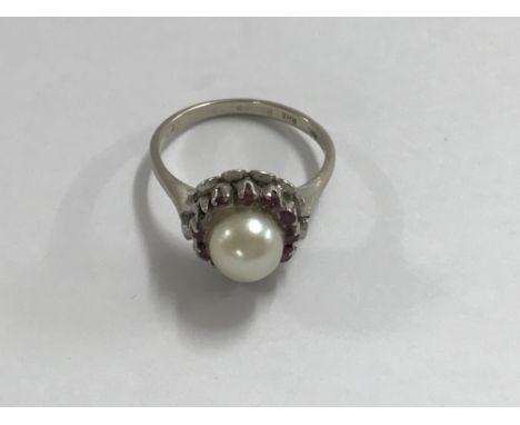 A 18 ct white gold ring inset with single pearl ruby chips size M . Total 3 grams.