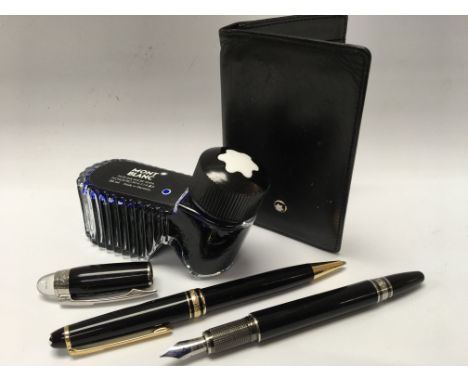 Two Mont Blanc pens, one being Meisterstuck, together with an Mont Blanc inkwell and wallet