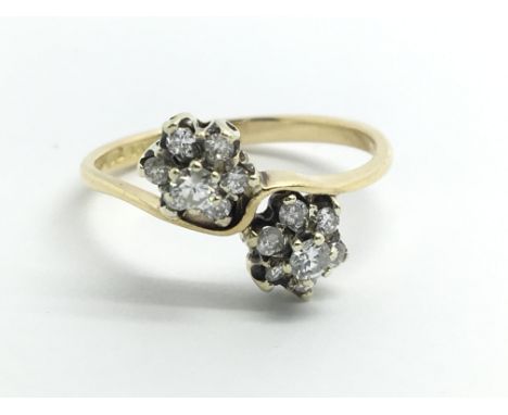 An 18ct yellow gold and diamond multi cluster ring, size approx M