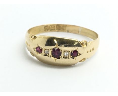 A vintage 18ct yellow gold ring set with three rubies and two diamonds, approx size S/T