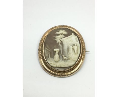 A vintage cameo depicting figures and buildings, approx height 4.5cm.