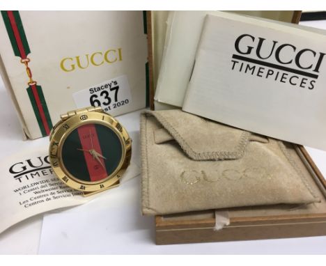 A Gucci Gold plated 0300 Bellissimo travel clock with original box and paperwork.