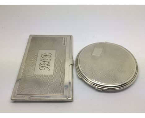 A silver compact and a silver card case (2).