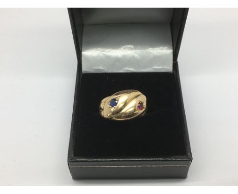 An antique gold snake ring set with a single ruby and a sapphire to the eye, approx