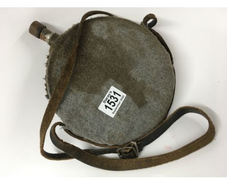 An old horn powder flask with leather strap handle and a water bottle with leather strap