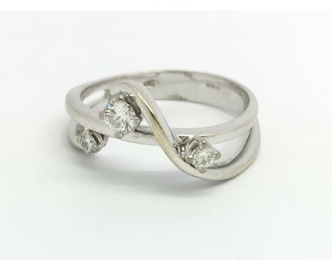 An 18ct white gold and diamond fancy three stone diamond ring, approx size N/O