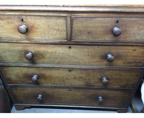 A Victorian mahogany chest of drawers fitted with two short and three long drawers on bracket feet .