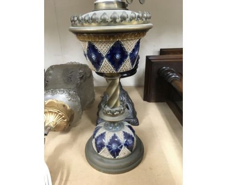 A oil lamp with Doulton style font together with two other lamps .
