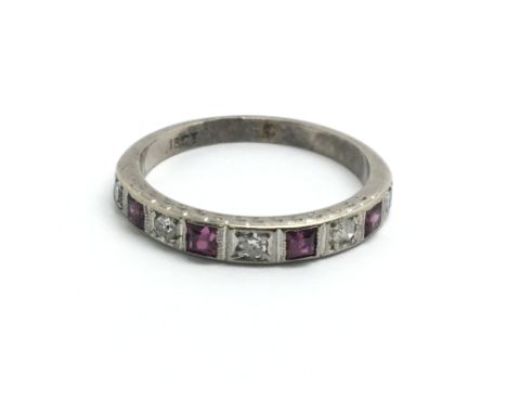 An 18ct white gold half eternity ring set with alternating rubies and diamonds, ring size K