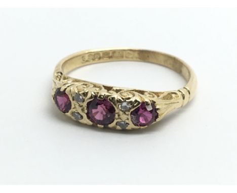 A vintage 18ct yellow gold ring, set with three rubies and four diamonds, ring size approx K/L